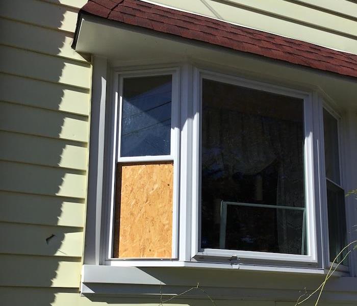 Window on home boarded up by SERVPRO